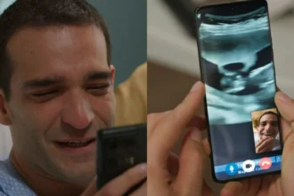 Afonso (Humberto Carrão) segura celular com duas mãos e tapa a boca com outra em Vale Tudo.